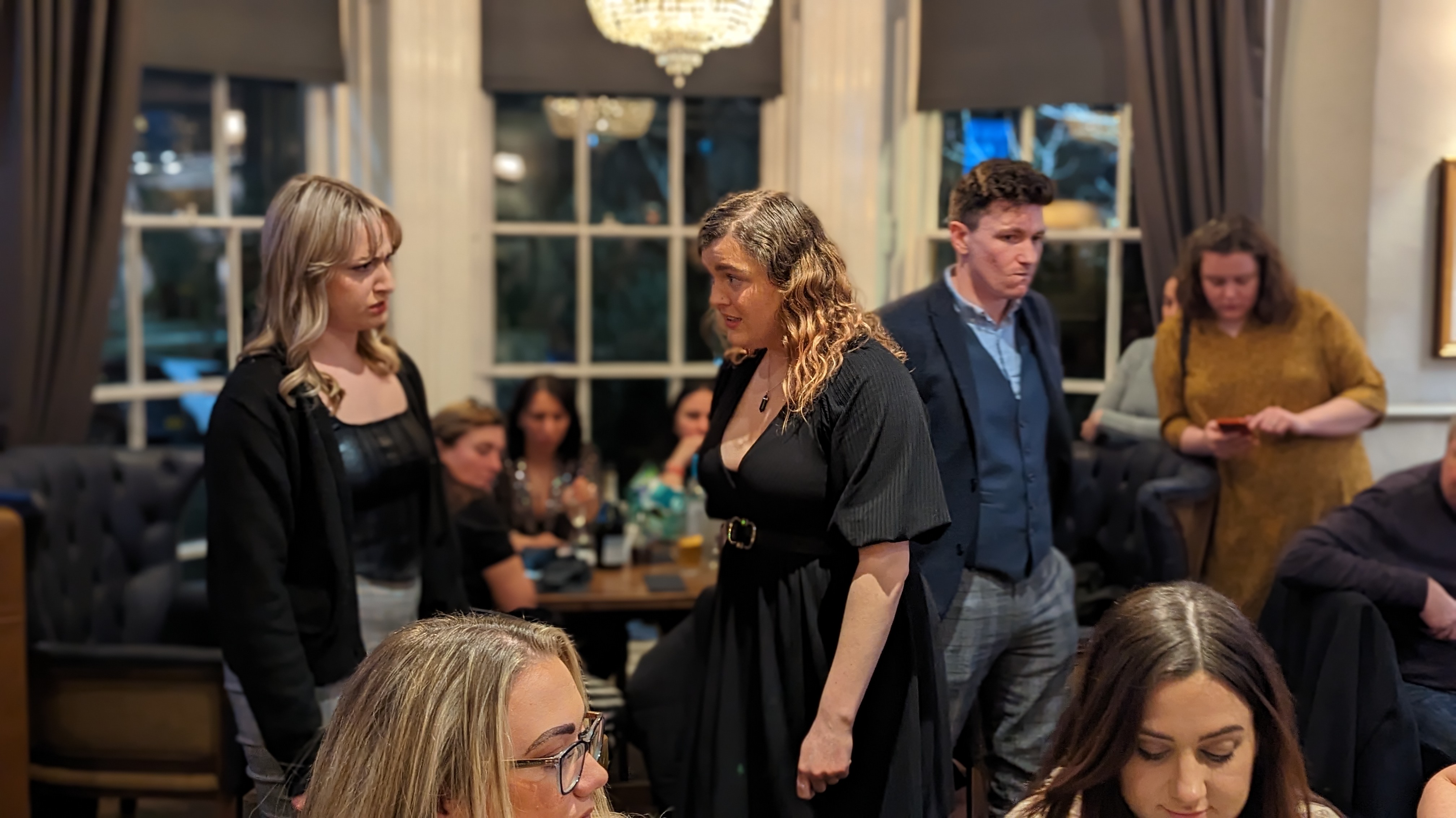 Alara actors performing among dinner guests at The Clock Face