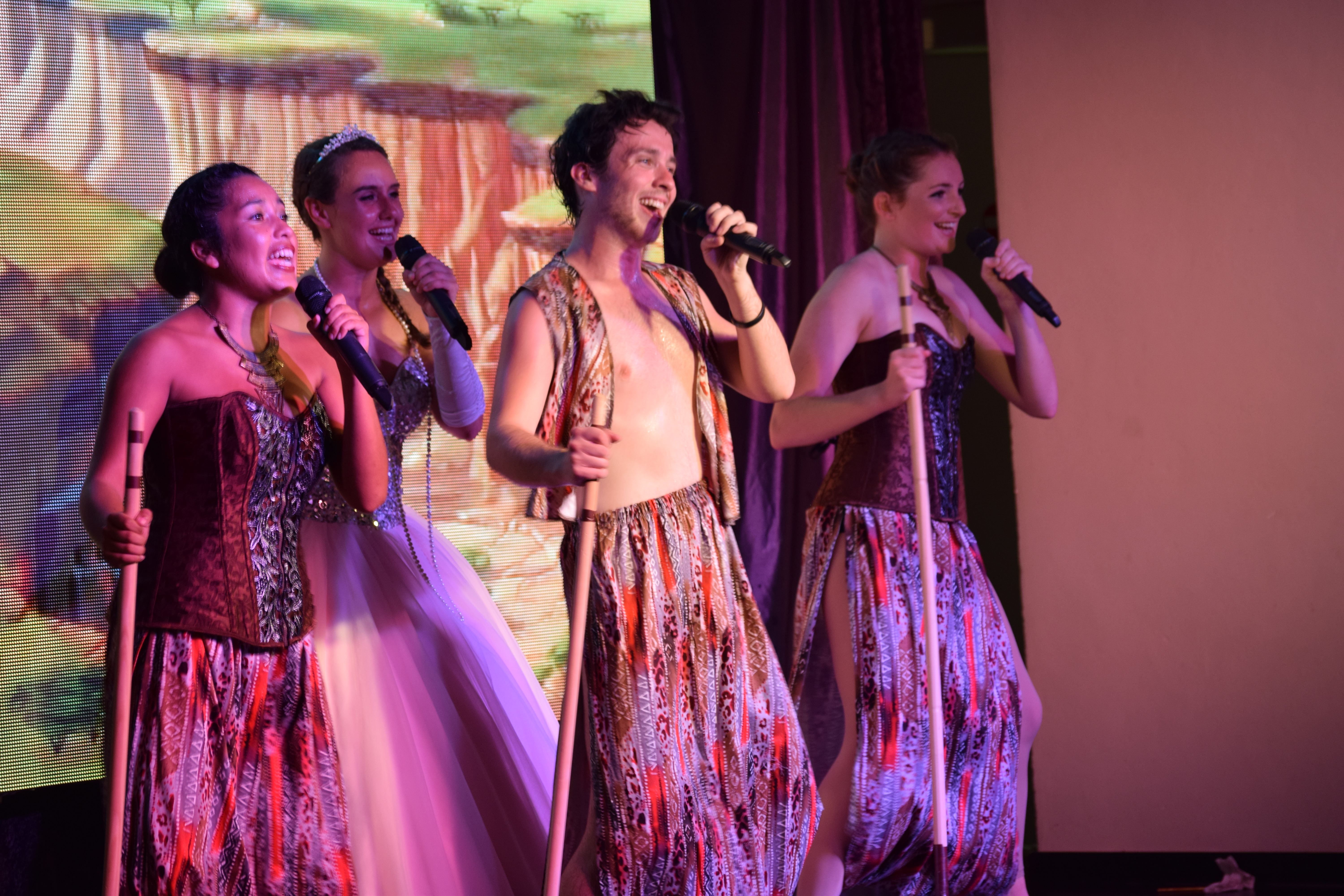 Costumed singers performing together on stage
